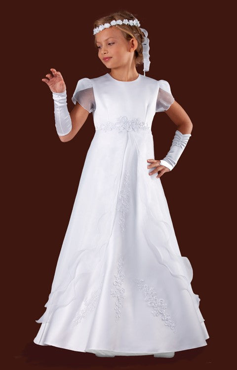 A girl wearing a brand-new white communion dress with flutter sleeves