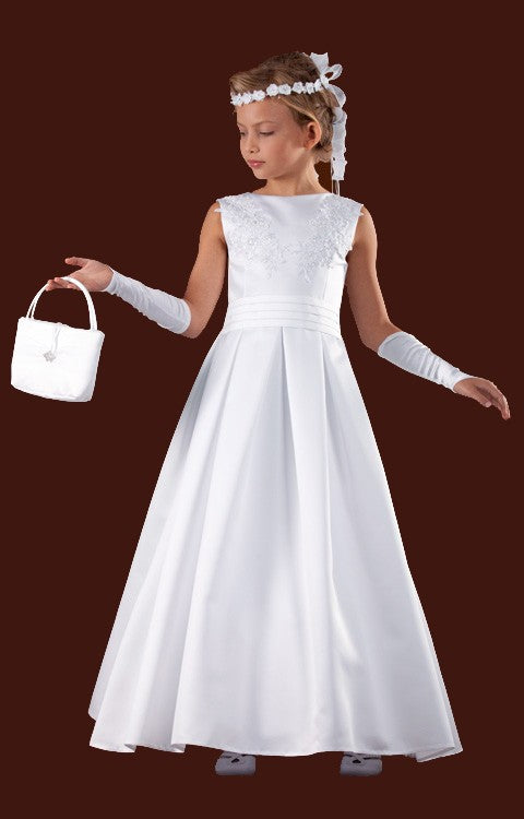 A girl wearing a brand-new white satin communion dress with a handbag