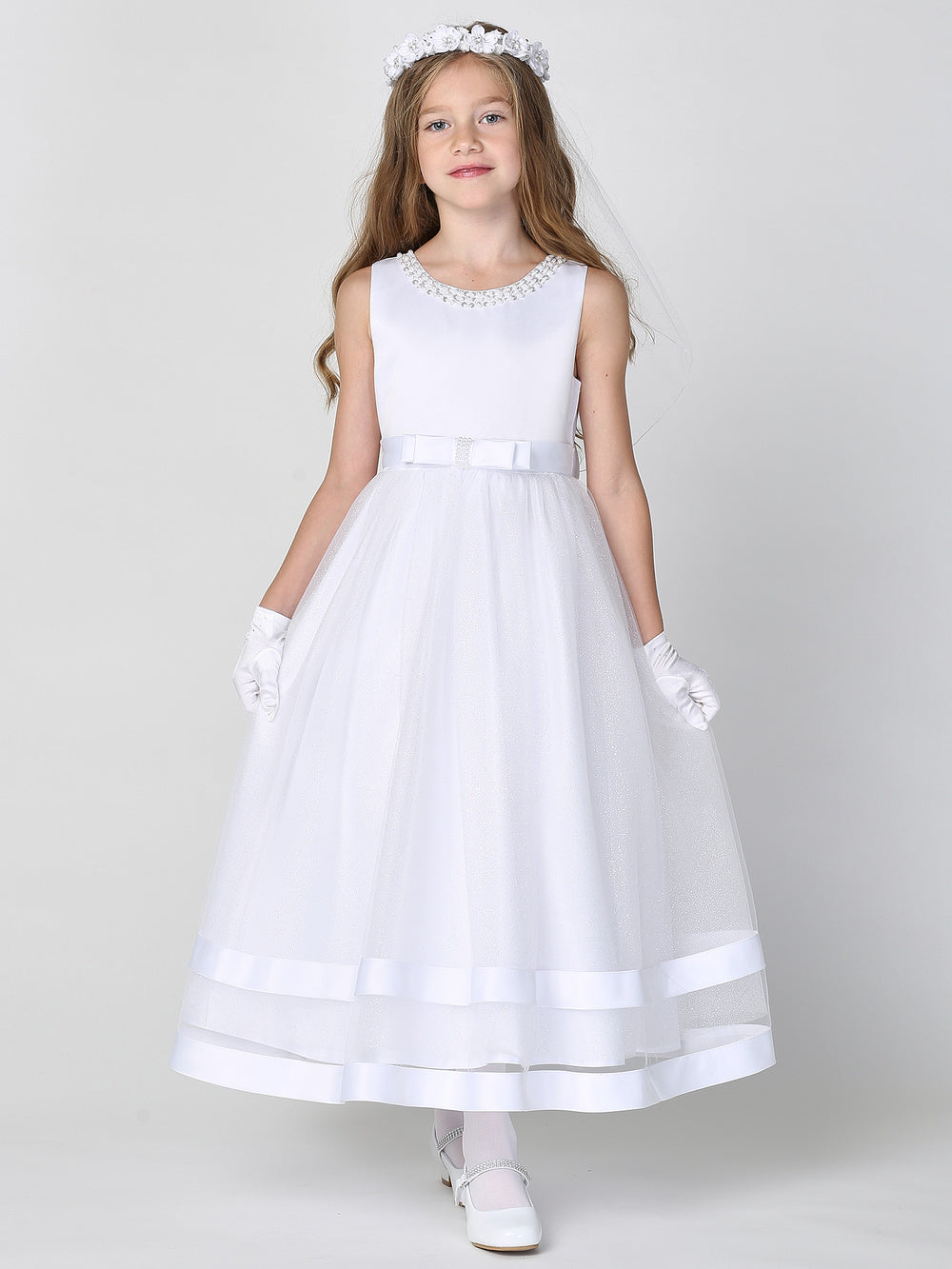 A girl wearing a brand-new white organza communion dress
